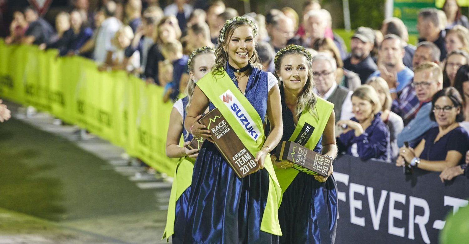 Podiumgirls präsentieren die Trophäen des Race Around Austria